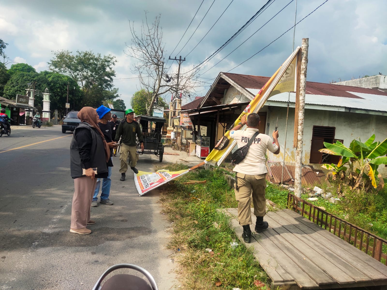 Koordinator Divisi Penyelesaian Sengketa dan Penanganan Pelanggaran Bawaslu Kota Langsa, Marida Fitriani MP, serta anggota Bawaslu bersama Satpol-PP Kota Langsa saat menurunkan sejumlah baliho dan spanduk Alat Peraga Kampanye (APK) dalam wilayah Kecamatan Langsa Kota, Minggu (11/2)